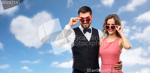 Image of happy couple in heart-shaped sunglasses