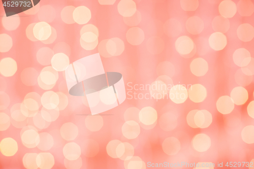 Image of blurred bokeh lights in living coral color