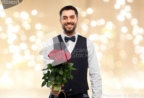 Image of happy man with bunch of red roses