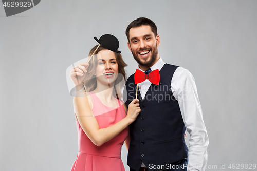 Image of couple with party props having fun and posing