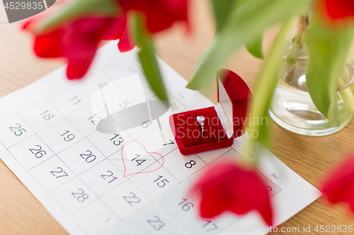 Image of diamond ring and calendar sheet on valentines day