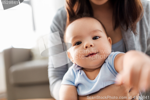 Image of close up of asian baby boy with mother