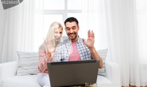Image of couple with laptop having video call at home