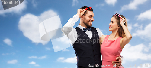 Image of happy couple in heart-shaped sunglasses