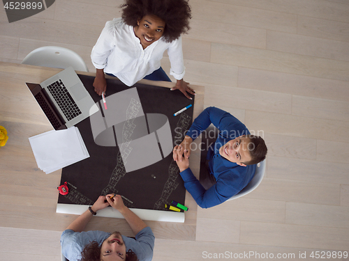 Image of top view of Multiethnic startup business team on meeting