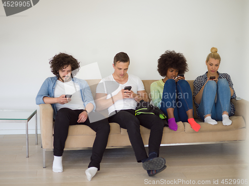 Image of multiethnic group of young people staring at smartphone