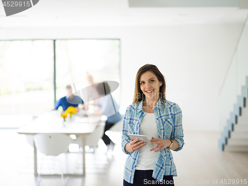 Image of Portrait of  smiling casual businesswoman using tablet  with cow