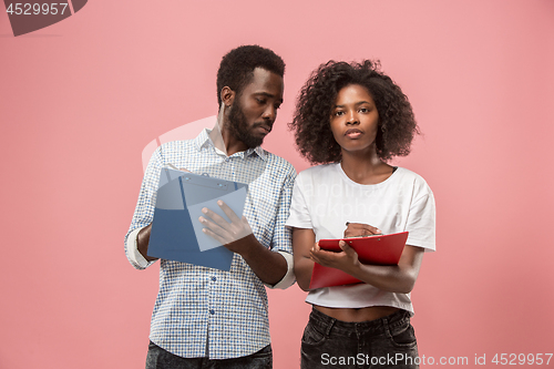 Image of Two african students with folders in t-shirts together. Stylish girl with Afro hairstyle and her boyfriend.