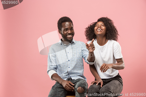 Image of Couple watching sports match on tv at home, celebrating victory, successful game