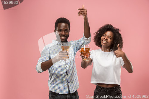 Image of The afro couple or happy young people laughing and drinking beer at studio