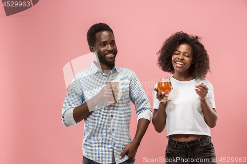 Image of The afro couple or happy young people laughing and drinking beer at studio