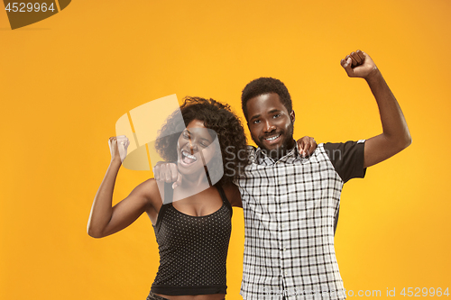 Image of Winning success couple celebrating being a winner. Dynamic energetic image of afro models