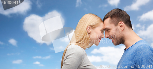 Image of couple forehead to forehead over festive lights