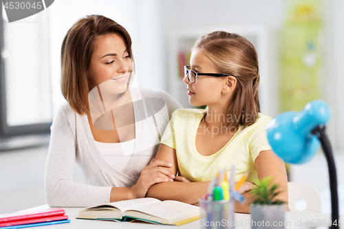 Image of mother and daughter doing homework together