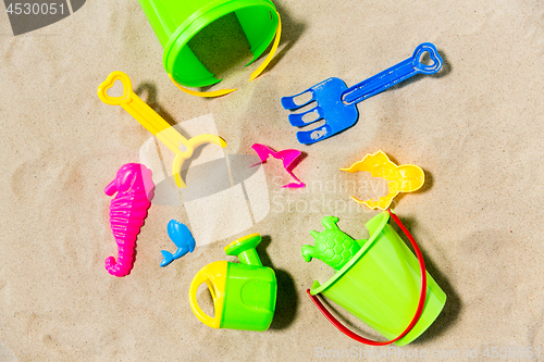 Image of close up of sand toys kit on summer beach