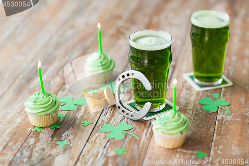 Image of glass of beer, cupcakes, horseshoe and gold coins