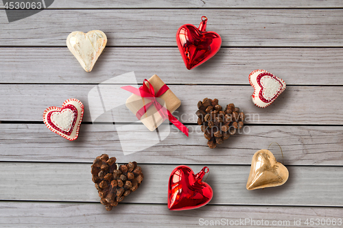 Image of christmas gift and heart shaped decorations