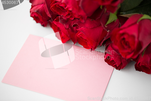 Image of close up of red roses and letter or note