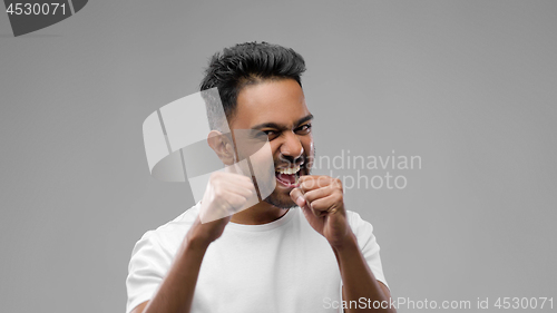 Image of indian man pretending fighting or boxing