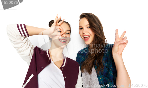 Image of happy smiling teenage girls making gestures