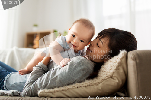 Image of happy mother with little baby son at home