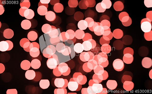 Image of blurred bokeh lights in living coral color