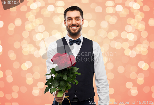 Image of happy man with bunch of red roses