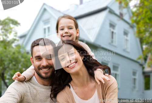 Image of happy family over house background