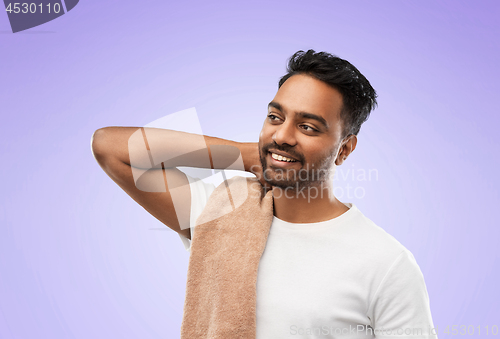 Image of indian man with towel over violet background