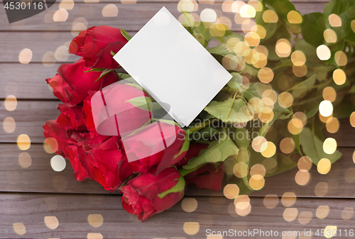 Image of close up of red roses and note