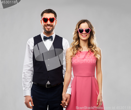 Image of happy couple in heart-shaped sunglasses