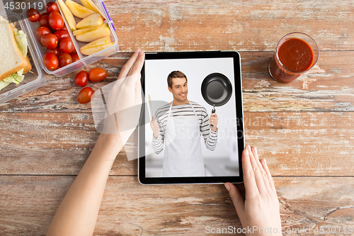 Image of woman watching cooking video on tablet computer