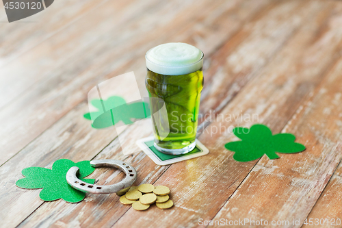 Image of glass of green beer, horseshoe and gold coins