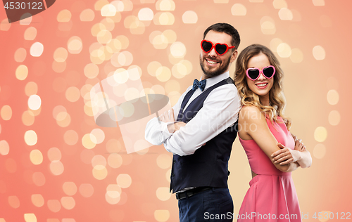 Image of happy couple in heart-shaped sunglasses