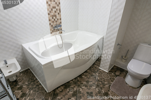 Image of Interior of a large bathroom combined with a toilet