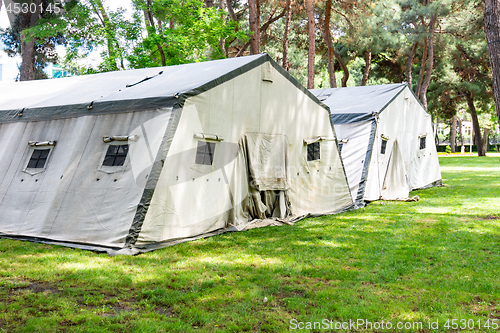 Image of Big tents of the Ministry of Emergency Situations, laid out on the lawn in the forest plantation