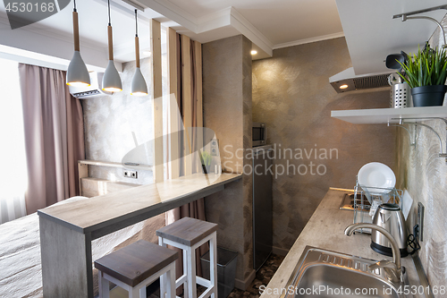 Image of View of the kitchen and bar in a small hotel room - studio