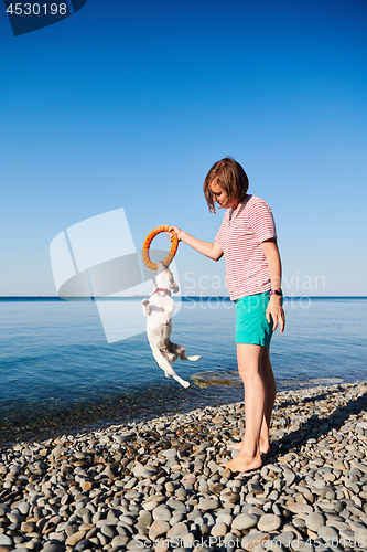 Image of Woman play with her dog