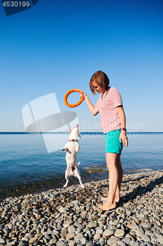 Image of Woman play with her dog