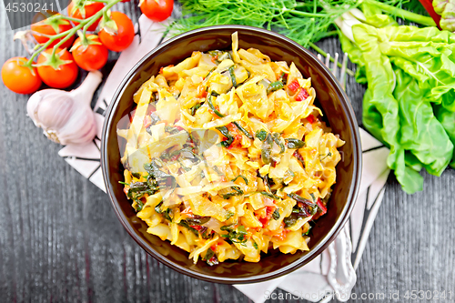 Image of Cabbage stew with chard in bowl on dark board top