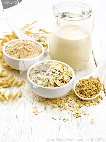 Image of Oat flakes with flour and milk on light board