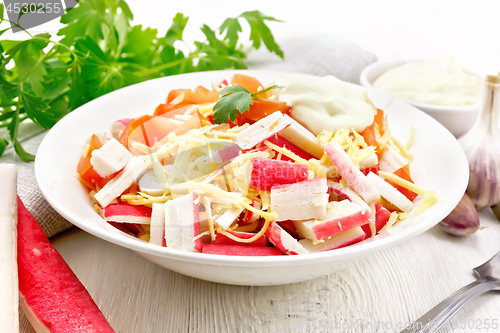 Image of Salad of surimi and tomatoes on board