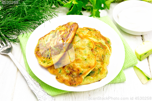 Image of Pancakes of zucchini on wooden board