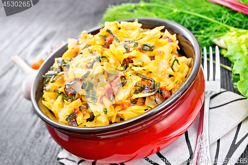 Image of Cabbage stew with chard in bowl on napkin