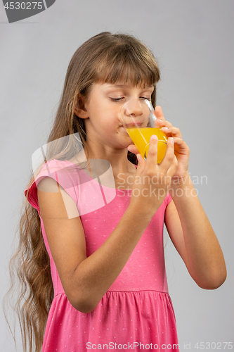 Image of Girl drinking orange juice from a glass