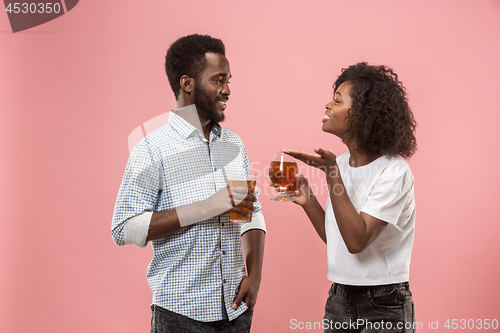 Image of The afro couple or happy young people laughing and drinking beer at studio