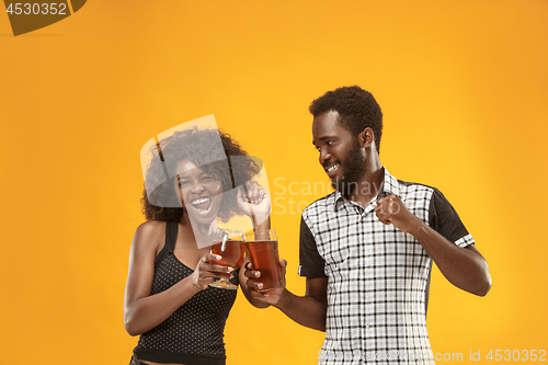 Image of The afro couple or happy young people laughing and drinking beer at studio