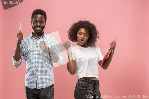 Image of Two african students with folders in t-shirts together. Stylish girl with Afro hairstyle and her boyfriend.