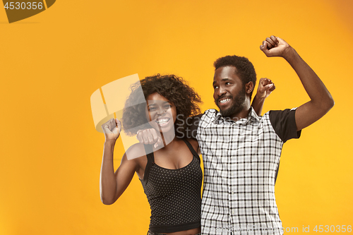 Image of Winning success couple celebrating being a winner. Dynamic energetic image of afro models