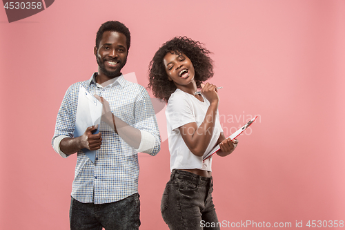Image of Two african students with folders in t-shirts together. Stylish girl with Afro hairstyle and her boyfriend.